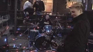 Police Officer Responding to Noise Complaint Jumps on Drums for Jam Session