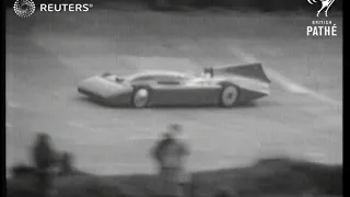 Sir Malcolm Campbell drives his car, Bluebird, around the track at Brooklands (1935)