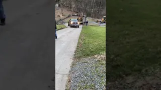 The Cummins towing a backhoe up hill