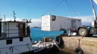 Container falls in water taking out boat and truck