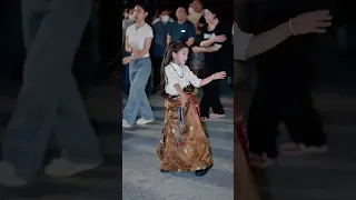 Beautiful little girl dancing Tibetan dance on the streets of China, Chengdu, Shanghai,, street