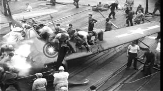 A US Navy F6F Hellcat fighter aircraft belly-lands on the deck of USS Essex under...HD Stock Footage