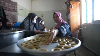 Displaced Palestinians bake cookies and sew clothes to mark Eid despite war