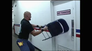 Stone Cold Steve Austin goes Nuts and tries to kick down Hart Foundations Locker Room Door.