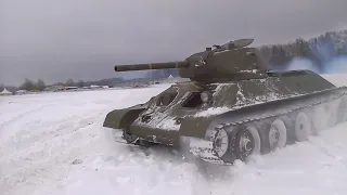 WW2 T-34-76 Tank moves through the snow.