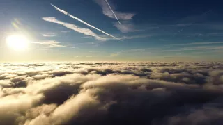 dji f550 hexacopter drone flight above the clouds