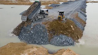 Really Great Operator Bulldozer and Dump Truck Work in Processing Build Road by Stone on Water