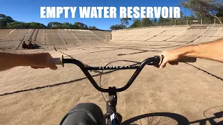 Riding an empty water reservoir on BMX