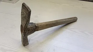 Restoration of a rusty construction pickaxe. Engraving. Making a new handle