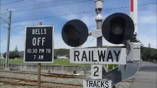 Northbound train with railway crossing bells - and background