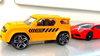 Various cars driving on windowsill. Driving small model cars by hand.