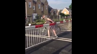 Lucky to be alive Man barging through a level crossing with his bike before almost being killed by a