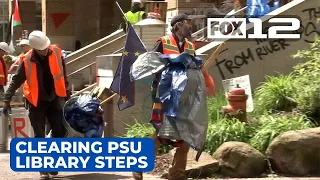 Workers clear away signs, barricade from PSU library steps