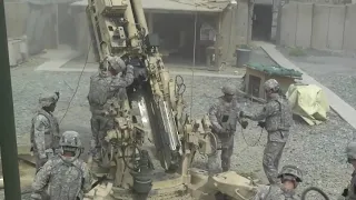 US Army Artillerymen Fire Howitzer In Afghanistan