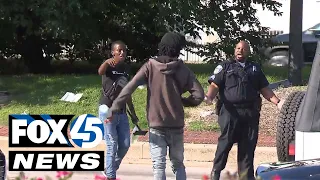 Squeegee kid and police officer in verbal confrontation Downtown Baltimore