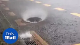 Crazy moment manhole cover dances in heavy rain