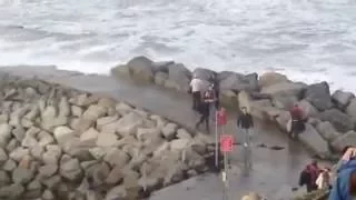 Man gets knocked over by big wave on Whitby harbour