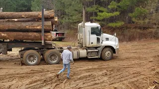 Mack Truck Pulling a Hill loaded with Logs