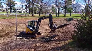 Forks on excavator moving across approximately 2 ft of mud one Matt at a time