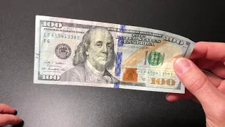 How to spot a fake $100 dollar bill