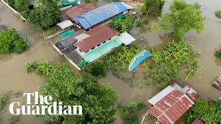 Thai paramotorists fly over flooded areas to drop off essential supplies