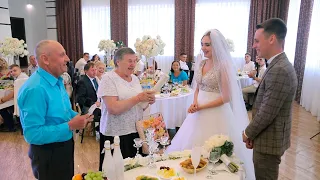 Дедушка с бабушкой поздравляют молодожёнов на свадьбе