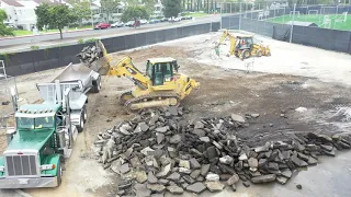 Breaking up Concrete Pavement and Asphalt with a Caterpillar 973 Track Loader