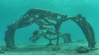 Mermaid swimming through Sea Sculpture in Cozumel