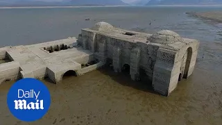 Drone captures submerged 16th century church revealed by drought - Daily Mail