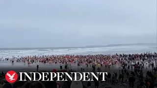 Swimmers run into icy sea for New Year's Day dip on Devon beach