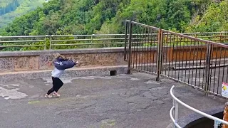 Strong wind blowing girl at Pali Lookout