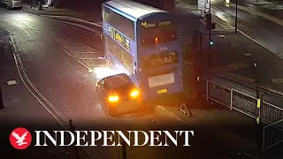 Moment speeding car collides with bus and causes it to crash into house