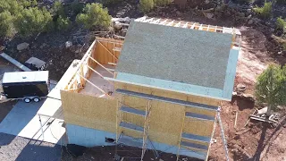 Sheathing the roof on our off-grid home