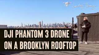 DJI Phantom 3 drone on a Brooklyn rooftop overlooking New York skyline