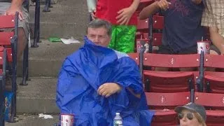 Fan struggles to put on poncho at Fenway Park