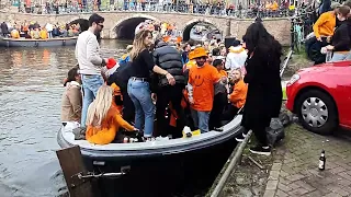 Kingsday 2023 -  Crowded crossing at Amsterdam canal.