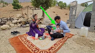 "Happiness for Maryam and her baby next to her husband: trying to build a new hut"