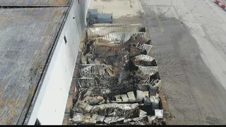 Smoke clears, showing damage from fire at Walmart warehouse