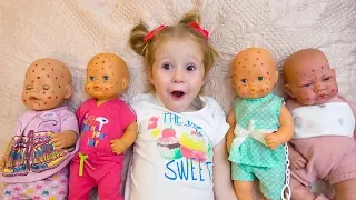 Babies dolls and funny little girl playing together