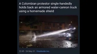 Colombian protestor single handedly holds back an armored water-cannon truck using a homemade shield