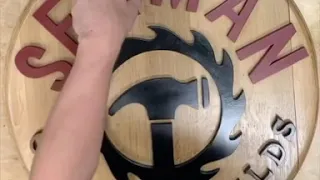 DIY shop sign made from barrel head and scroll saw cutouts!