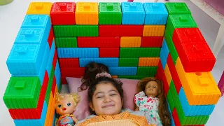 Oyku made a bed with Lego toys for her dolls