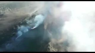 Drone footage of the cave in a volcanic vent with lava bombs flying miles high at La Palma volcano