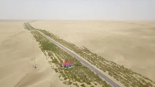 GLOBALink | Green energy applied in afforestation of desert highway in Xinjiang, China