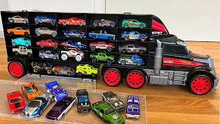 Small die cast model cars being carried by transportation vehicles