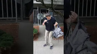 Random guy high on drugs almost falls over trying to put in back pack