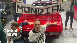 Climate activists glue themselves to sport cars at Paris Autoshow