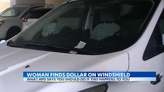 Woman reports dollar on her windshield, as it could be a trick by criminals