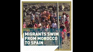 Migrants swim from Morocco to Spain