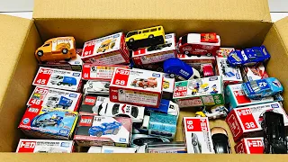 Box full of various miniature cars Peugeot, Volvo, Renault, Hyundai, Pagani, Cadillac One, DHL 88